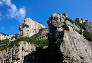 a rock cliff against a blue sky in the early morning at fangdong scenic area on yandangshan mountains located in zhejiang province china.