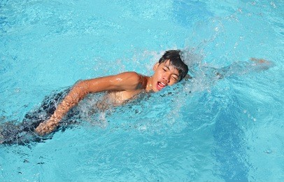 young asian swimmer in action