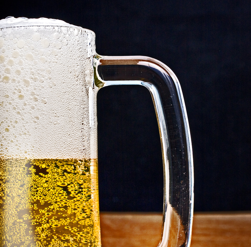 of fresh cold golden light beer with froth served in a glass