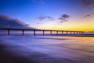 new brighton pier, christchurch, new zealand, sunrise - the pier at new brighton, christchurch, new zealand, at sunrise.