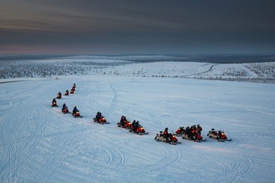 snowmobiles in motion. lapland, finland.