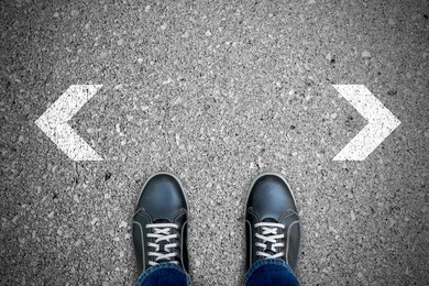 black casual shoes standing at the crossroad making decision which way to go.