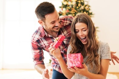 man giving a christmas present to his girlfriend
