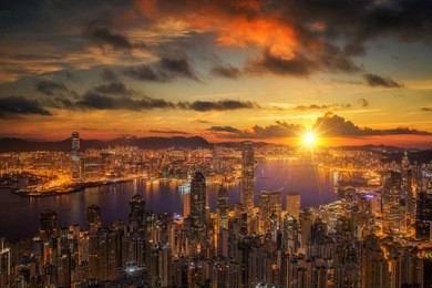 sunrise over victoria harbor as viewed atop victoria peak, hong kong, china