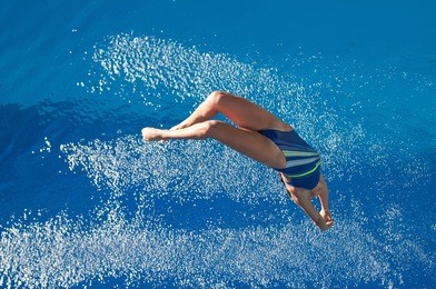 professional diver back flipping on the way down to water