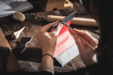 leather handbag craftsman at work in a workshop