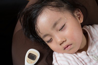 asian little girl gets high fever