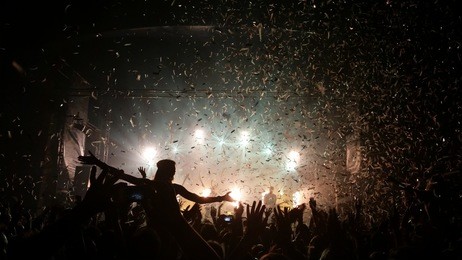 people enjoying good music at a concert - confetti falling 
