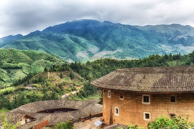traditional earthen tulou chinese huts, a landmark tourist attraction from the fujian province of china. these large round huts are still being lived in today by the hakka people.
