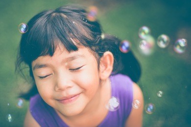 asian little girl happy with water bubble in vintage color tone