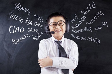 language learning concept. cute little boy learns multilingual while wearing headphones in the classroom