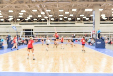 blurred image group of teen girls playing indoor volleyball. volleyball competition blur background. high school volleyball tournament concept.