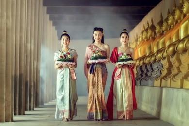 asia woman in thai dress traditional hold kratong.