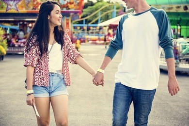 couple dating amusement park funfair festive playful happiness concept