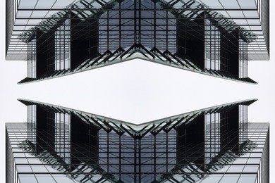 digitally composed photo of modern office buildings with all-over glazing structure viewed from low angle. unusual image of business city.