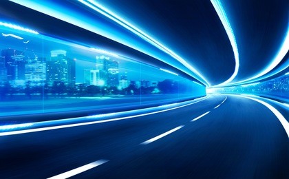 abstract blurred speed motion road in glass tunnel over the city