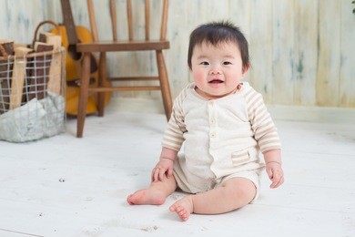 asian baby sitting on the floor