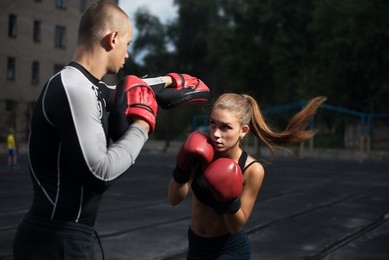 personal trainer coach men and women engaged in boxing at the stadium