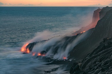 lava from the kilauea volcano, flows into the pacific ocean near kalapana, while people watch the spectacle from up above at volcanoes national park on the big island of hawaii. 