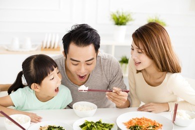 happy asian young family enjoy their lunch 