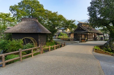 oshino hakkai historic village traditional thatch roof farmhouses and water wheel. fuji five lakes, japan