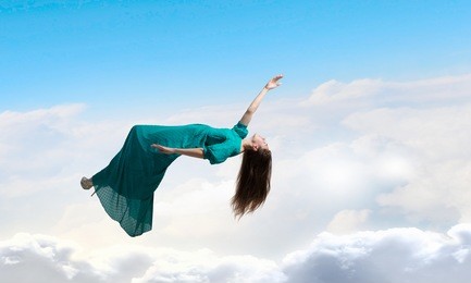 woman levitating in sky . mixed media