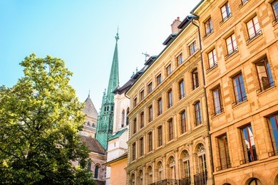street view with old buildings and saint pierre church's spire in the old town of geneva city in switzerland