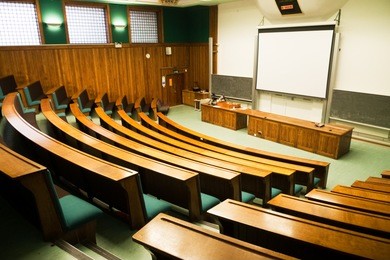 a wood panelled university lecture theatre/conference hall
