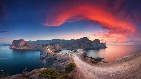 beautiful summer landscape with mountains, sea, blue sky and beautiful colorful red clouds at sunset in crimea. sunset in mountains. panoramic. nature background. vibrant landscape in twilight. 