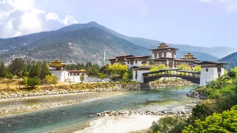 bhutan, punakha. the punakha dzong monastery and bridge across the river in bhutan one of the largest monestary in asia with the landscape and mountains background.