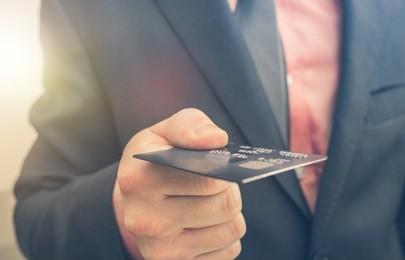 paying by credit card concept with businessman keeping credit card in his hand.