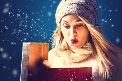 happy young woman opening a christmas present box