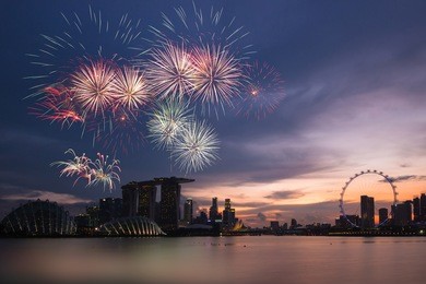 fireworks over bay ,silhouette building during sunset and sky twilight at singapore on national day rehearsal 