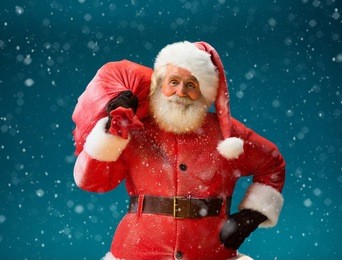 smiling santa claus carrying big bag full of gifts to children on blue background. merry christmas & new year's eve concept.