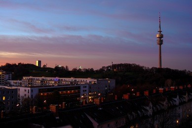 olympic tower and apartment building in munich at sunset