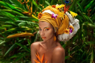 close up of young woman in turban with flowers