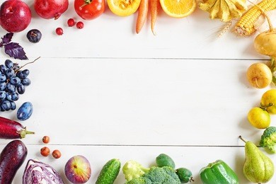 rainbow colored fruits and vegetables on a white table. juice and smoothie ingredients. healthy eating / diet concept.