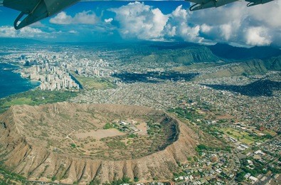 beautiful aerial view on a honolulu city from an airplane and diamond head crater on the island of oahu, hawaii, usa.