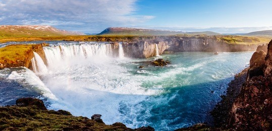 nice views of the bright sunlit powerful godafoss cascade. popular tourist attraction. unusual and picturesque scene. location bardardalur valley, skjalfandafljot river, iceland, europe. beauty world.