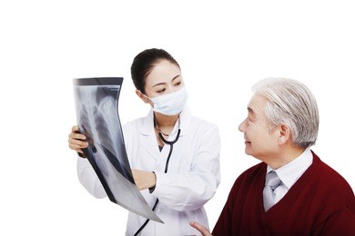 the doctor checking x ray film with patient