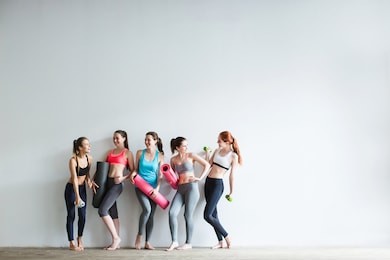 smiling women in fitness studio. fitness, sport, training and lifestyle concept.