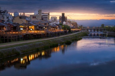 old house and restaurant in kamo river or kamogawa river at sunset, gion, kyoto, japan