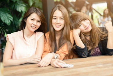 three beautiful happy asian girl smile and laugh together.image with sunlight filter.