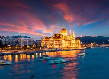 colorful evening view of parliament and chain bridge. dramatic sunset in budapest, hungary, europe. artistic style post processed photo.