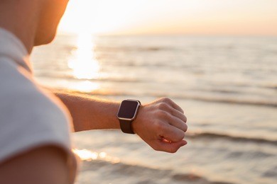 man looking at smartwatch