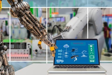 cyber - physical production or industry 4.0 benefit concept. robot arm is pressing laptop computer with industry 4.0 diagram on screen against the smart manufacturing workshop.