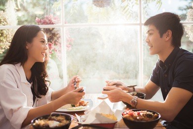  asian people eating at the restaurant in the morning.