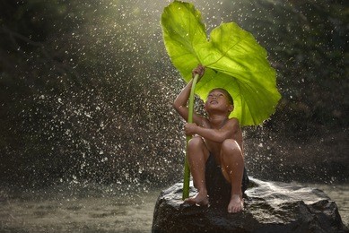 the people joy of a country boy local in laos  with nature boy waiting for rain..