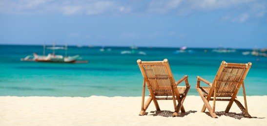 two beach chairs on perfect tropical white sand beach in boracay, philippines