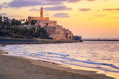 old town of jaffa over the sand beach bay on sunset, tel aviv, israel